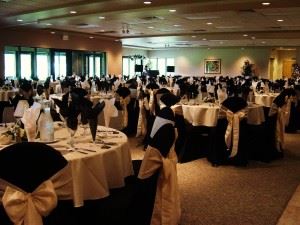 A banquet hall full of decorated tables.